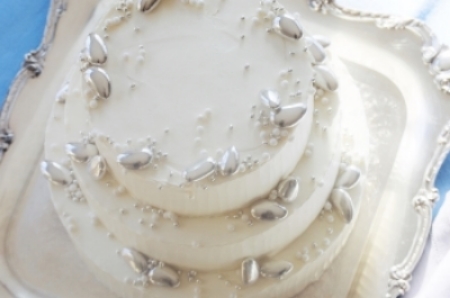 White Coconut Cake, Coconut Cream Filling, Italian Buttercream Frost Silver Jordan Almonds, Dragees and Sugar Pearls are jewels on this simply sophisticated cake.