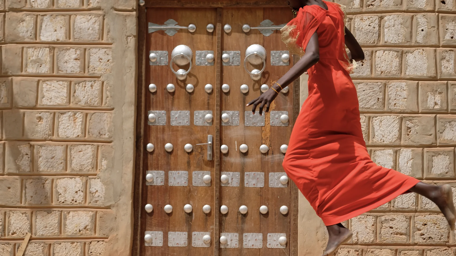 Aminata, age 15, jumps into the air in Timbuktu. She experienced severe trauma when she and her family were held at gunpoint by bandits on the roadside and they were taken overnight and kept in the forest. Her mother never recovered from the inciden…