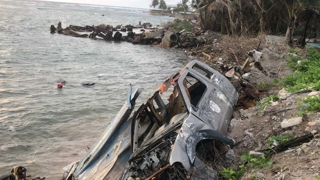 A rusted car makes up part of an improvised sea wall to stop erosion on Majuro atoll in the Marshall Islands. With rising sea levels and climate changes posing major challenges for the island nation, the government is investing in early childhood de…
