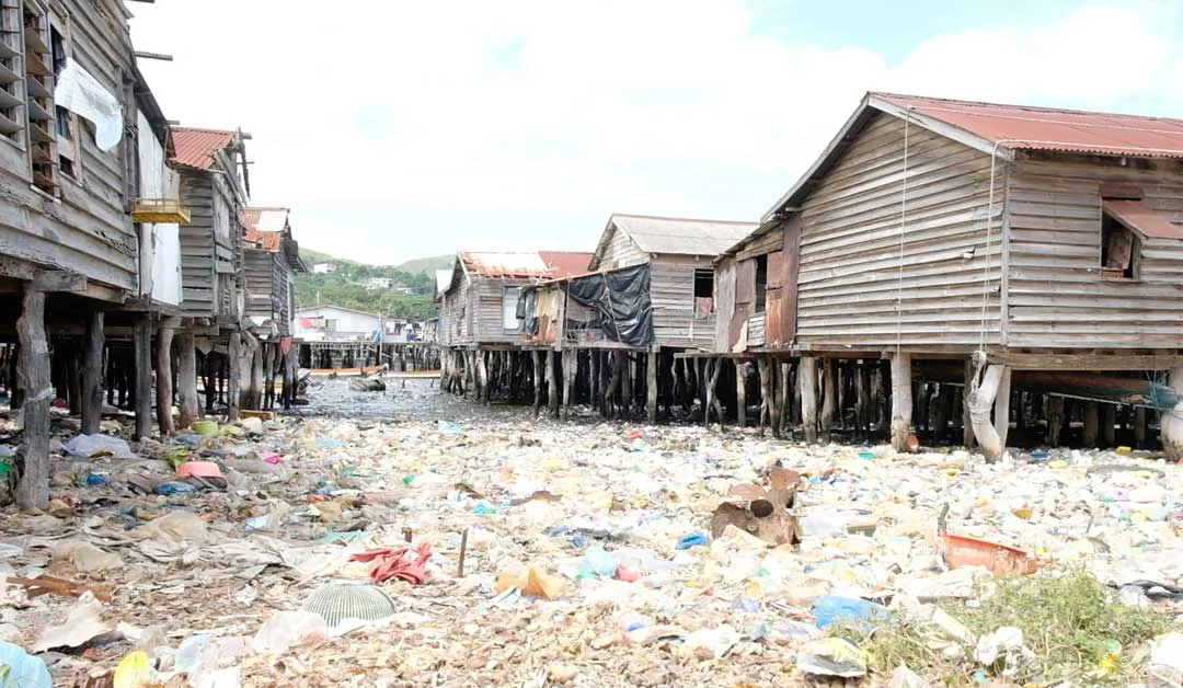 Plastic rubbish covers the ground in Hanuabada village in Port Moresby, Papua New Guinea. Limited services in rapidly growing settlements has created major public health problems that make it even harder for children to stay healthy and excel in sch…
