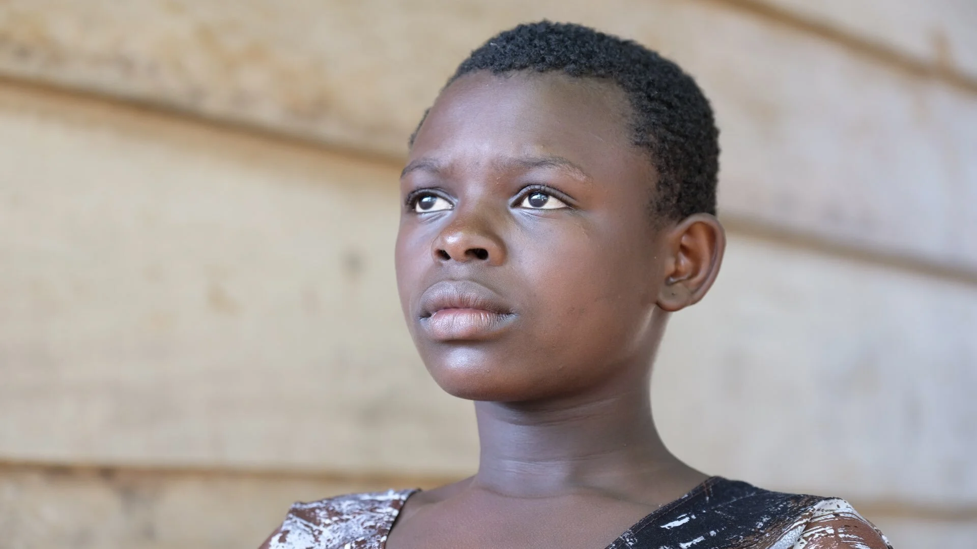 Rebecca got Ebola from her mother and the whole family ended up at the same treatment centre. Because they got treatment early, everyone survived so Rebecca is back in school and back into her normal life since she recovered from Ebola one year ago.