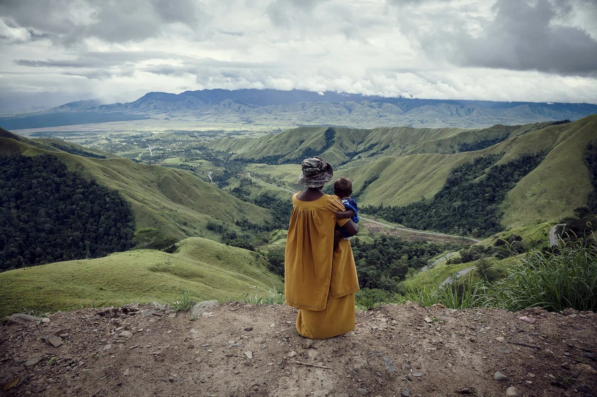 A woman looks down the valley from Kassam Pass, Morobe Province. The beautiful landscape of Papua New Guinea’s highlands belies the brutal reality of life in the region, where more than 90 percent of women report suffering gender-based violence.