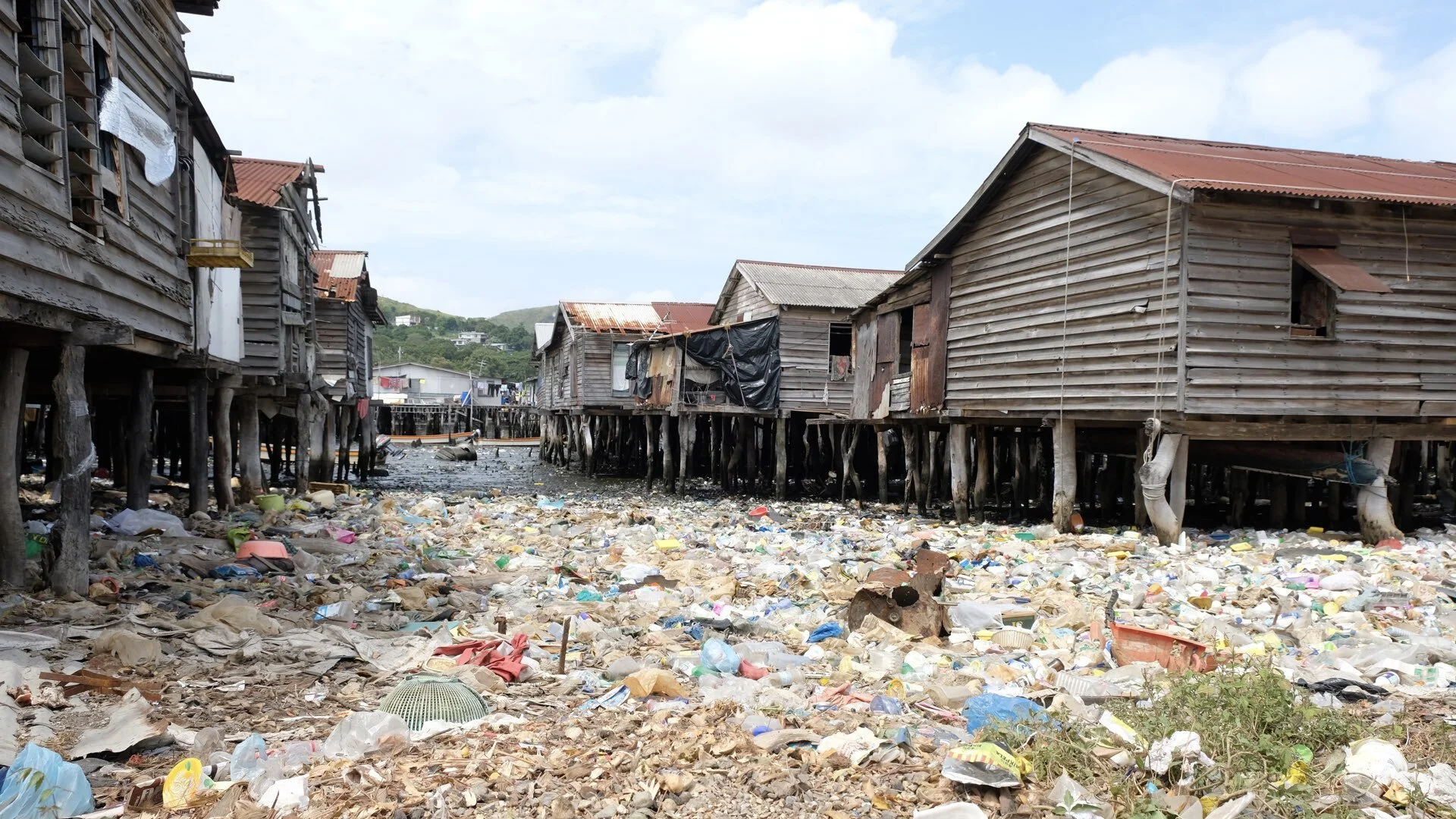 Plastic rubbish covers the ground in Hanuabada village in Port Moresby, Papua New Guinea. Limited services in rapidly growing settlements has created major public health problems that make it even harder for children to stay healthy and excel in sch…