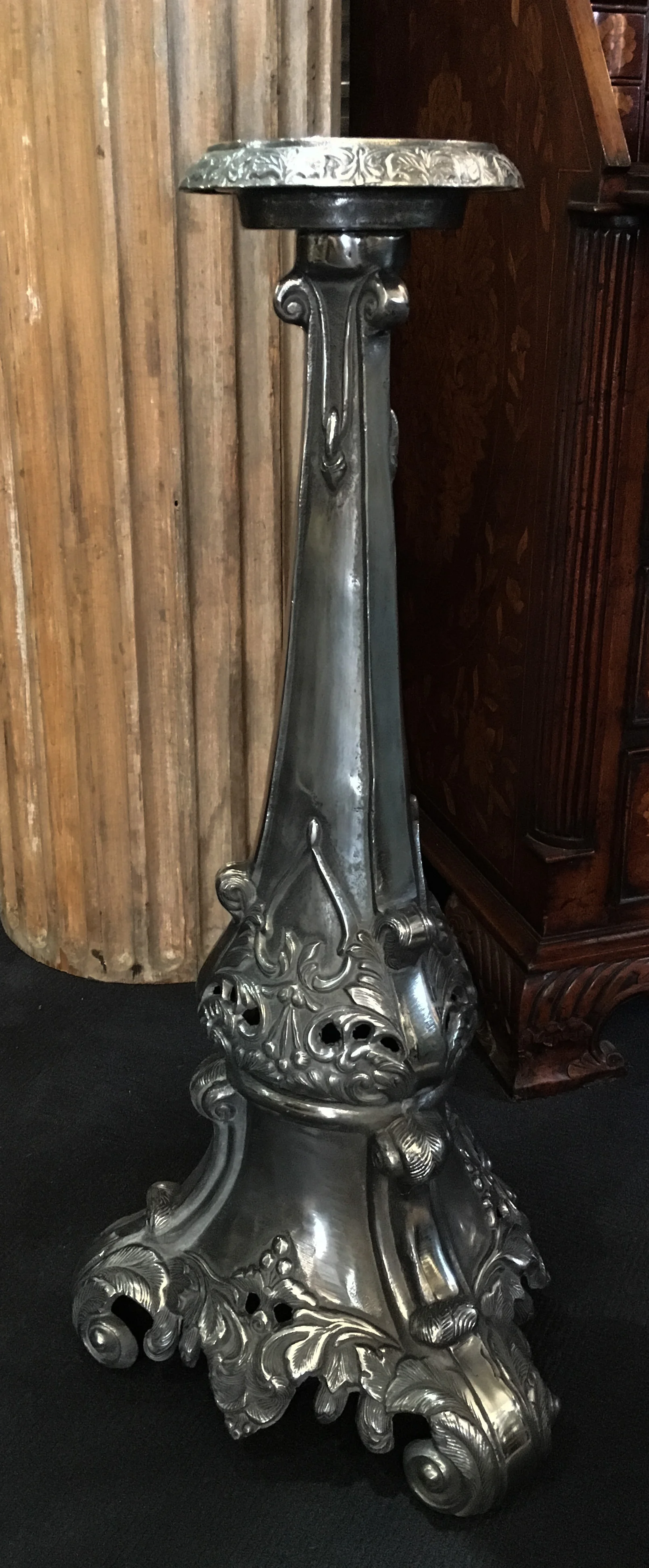 A very large ornate candlestick in polished metal.jpg