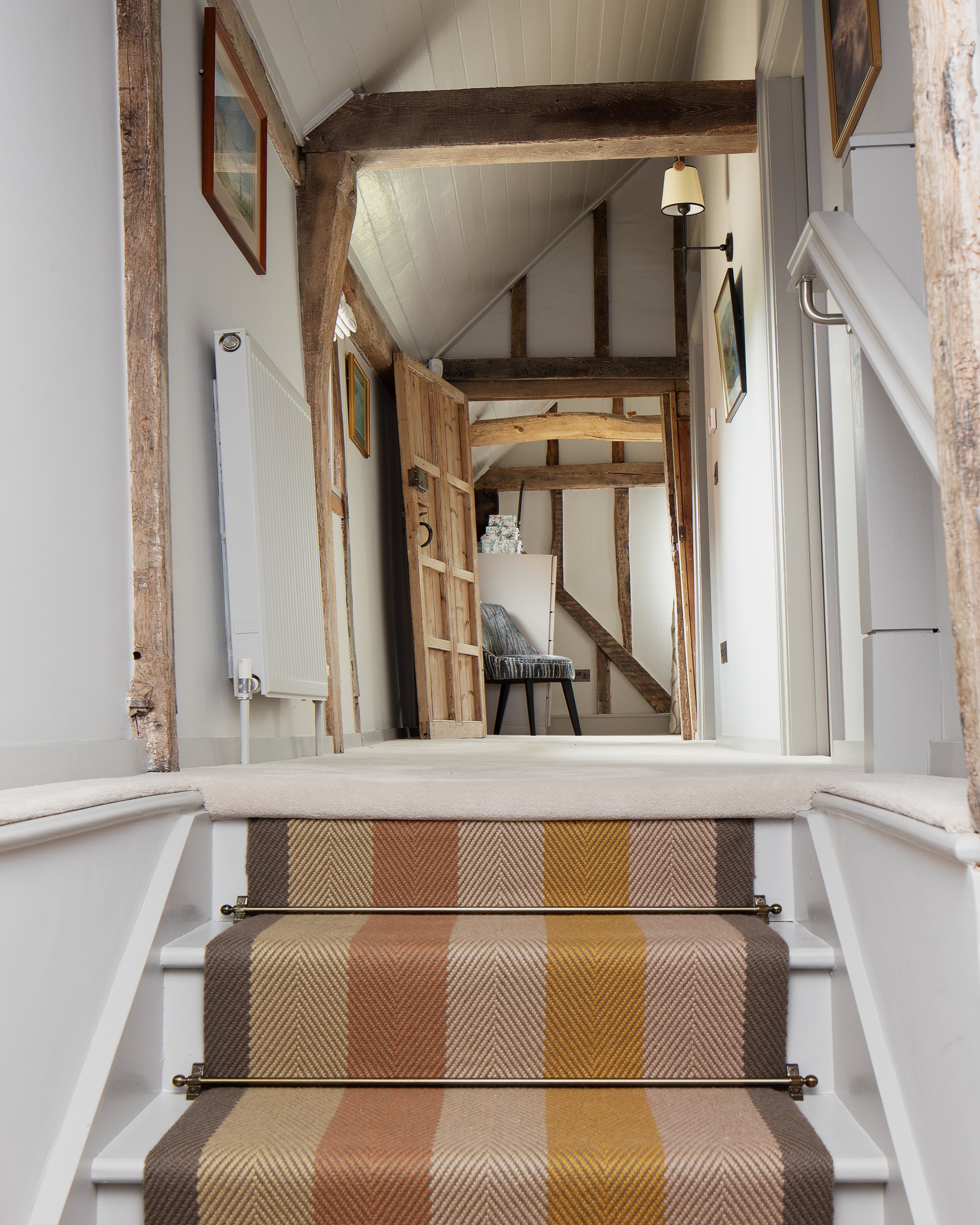 Cottage conversion stairs with striped runner.jpg
