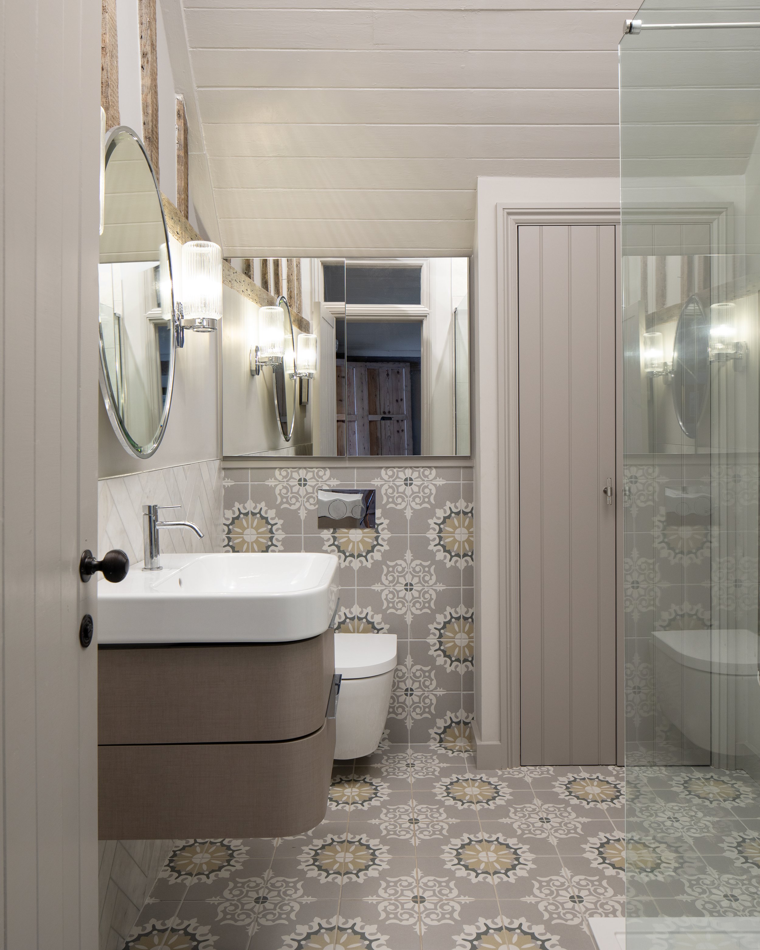 Cottage conversion bathroom with grey patterned tiles.jpg
