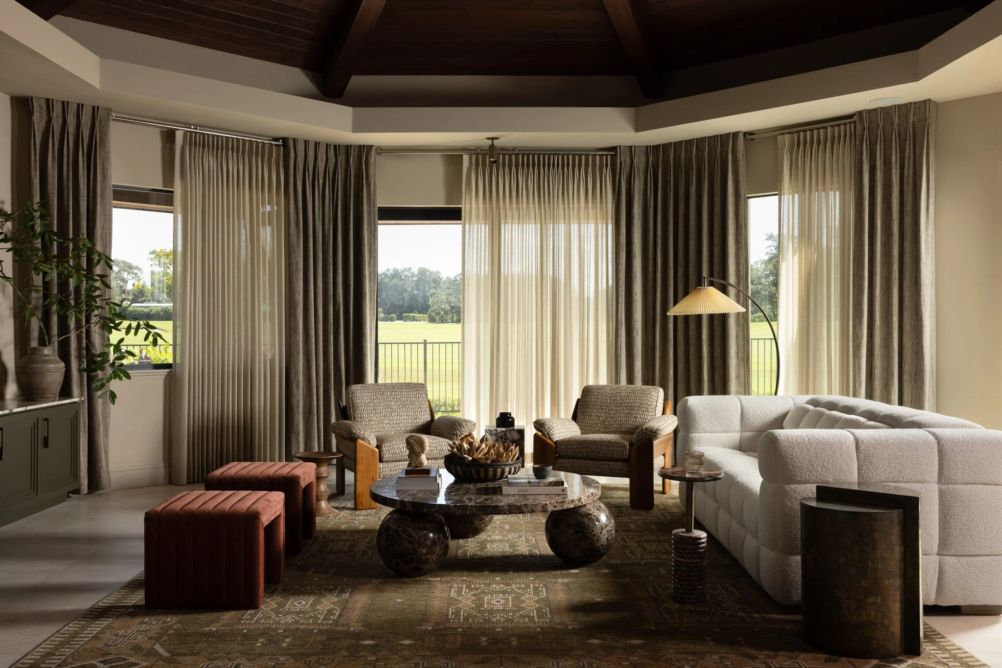 Warm, layered Main Line living room with modern furnishings and historic architectural details