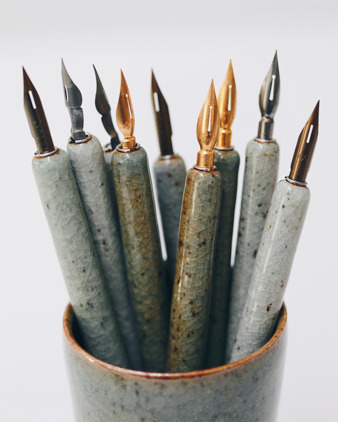 Ink dip pens, thrown off the hump and trimmed on the wheel too before being hand drilled to exact size that&rsquo;ll fit the metal ferrules, accounting for how much they&rsquo;ll shrink from wet clay to high fired stoneware&mdash;my clay shrinks abou