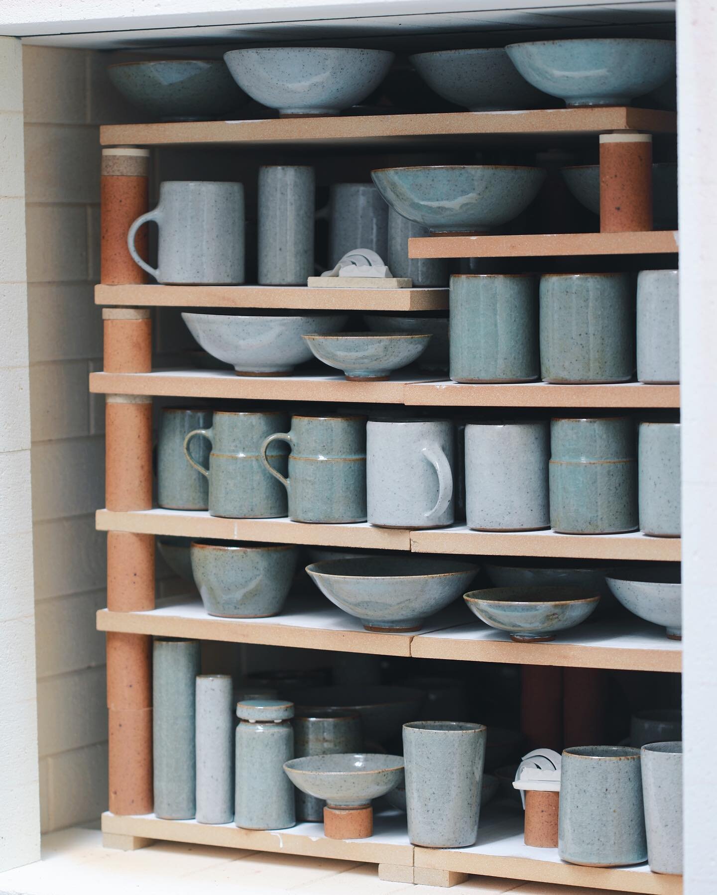 A view of the kiln, still cooling before it can be unpacked. Even with the door swung open it takes a while before I can handle the pots on the upper shelves. I unpack everything in order, from bottom to top, each layer laid out onto two ware boards,