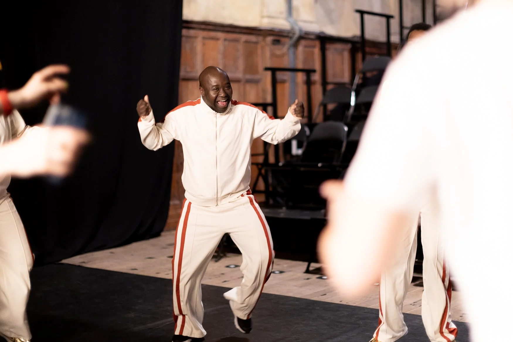 BLINK Co-Director Francis, a black man, has a huge smile on his face while dancing