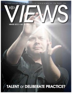 The cover of The Views magazine with Wink on the cover. Wink is wearing a black button up shirt signing the ASL word “Twirl around the town” with an added photo lens flair between his middle fingers