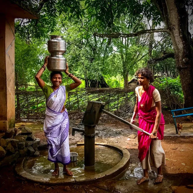 Women have to carry water long distances in tribal areas of Odisha, India, and sometimes are reluctant to be photographed at the source. This woman clearly didn't mind at all, and paused with over 40 pounds of water on her head to smile at me.