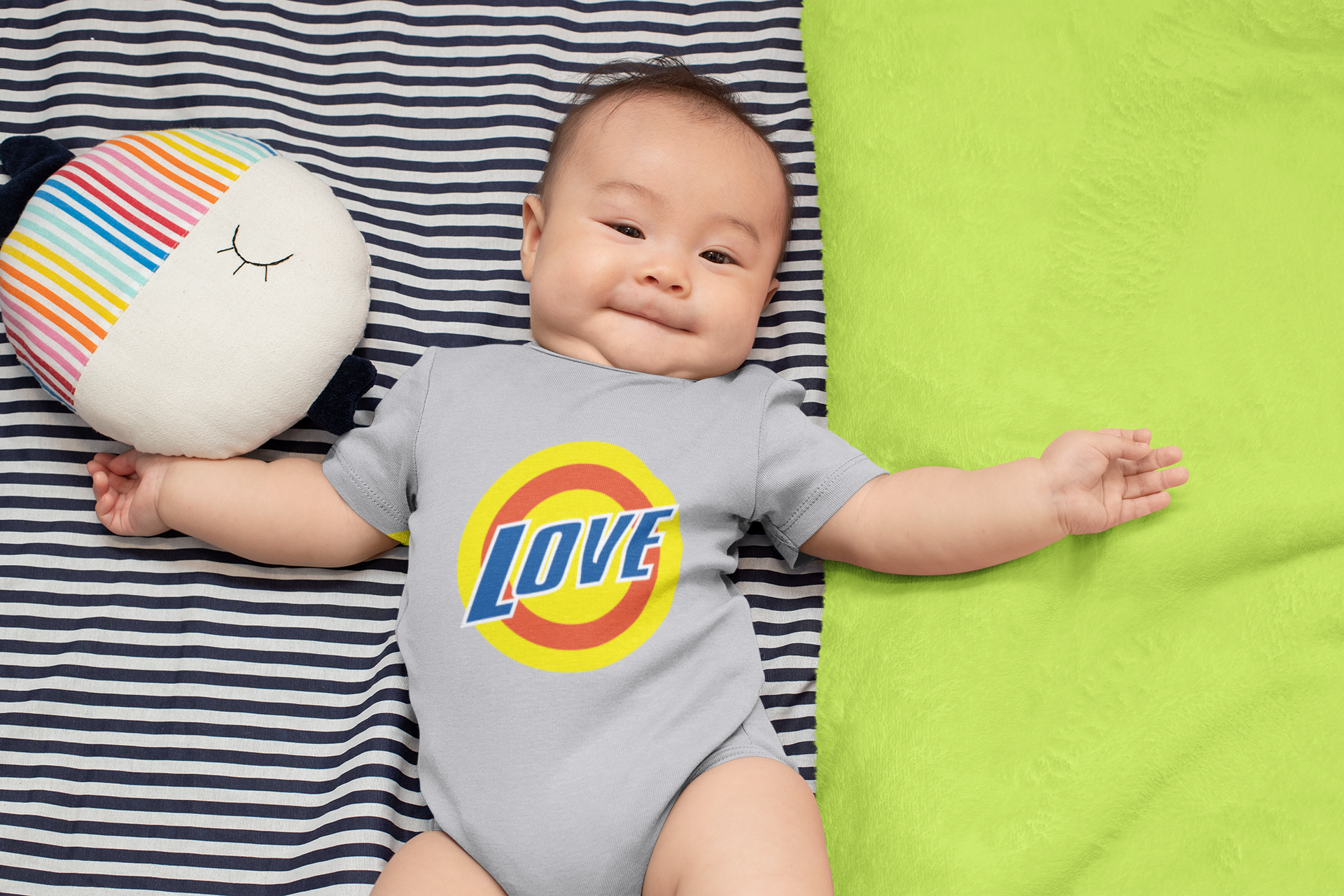 onesie-mockup-of-a-baby-boy-lying-on-a-blanket-30016.png