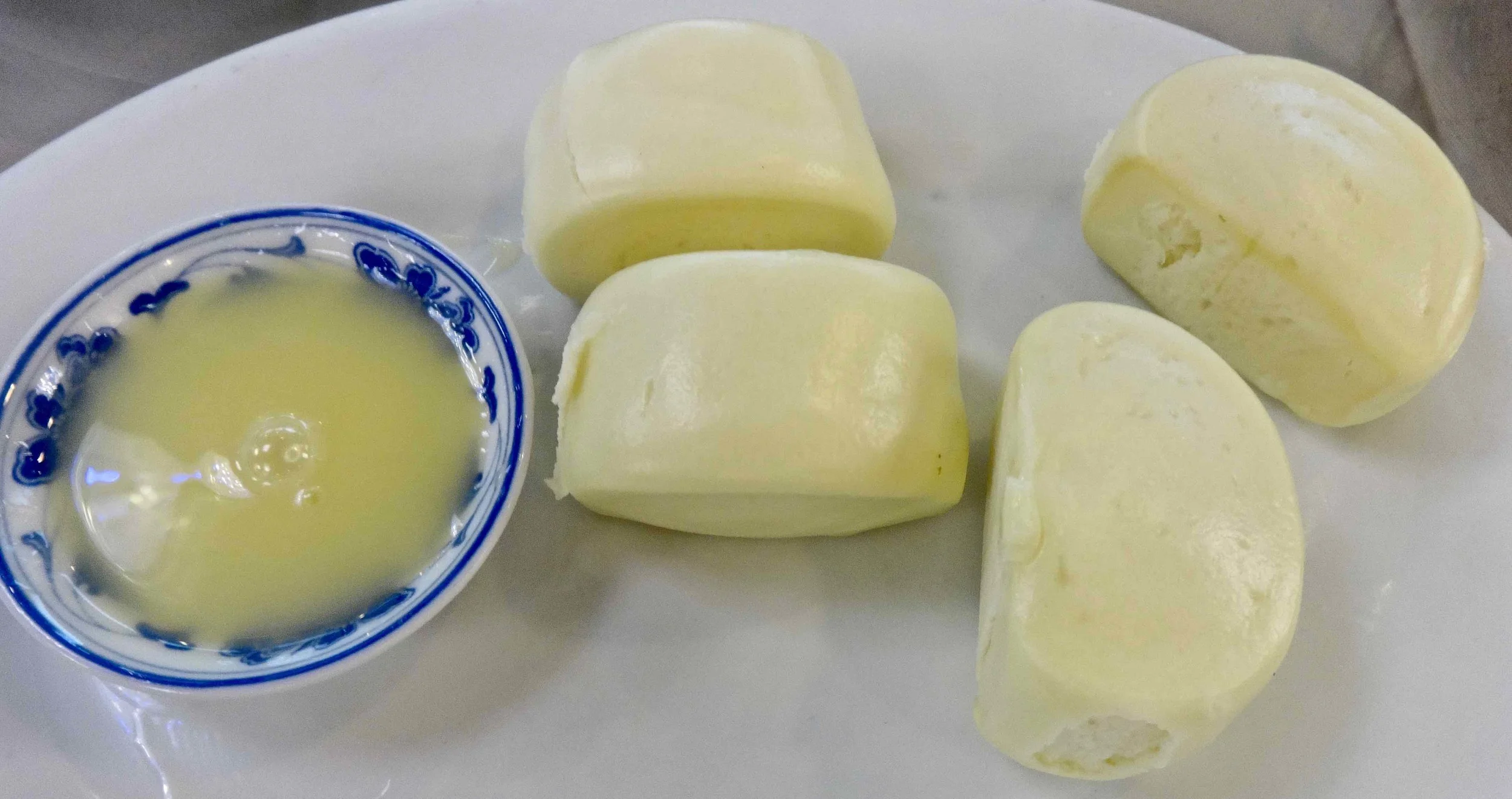 plain steamed buns and a dipping sauce. 