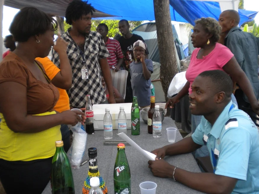 Baudeler with interested community members. Photo credit: SOIL.