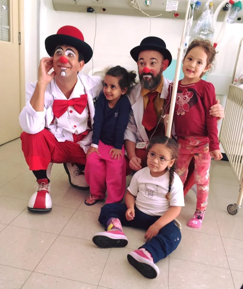 Nogueira with another clown colleague and children from one of their serviced hospitals. Photo credit: Doctors of Joy .