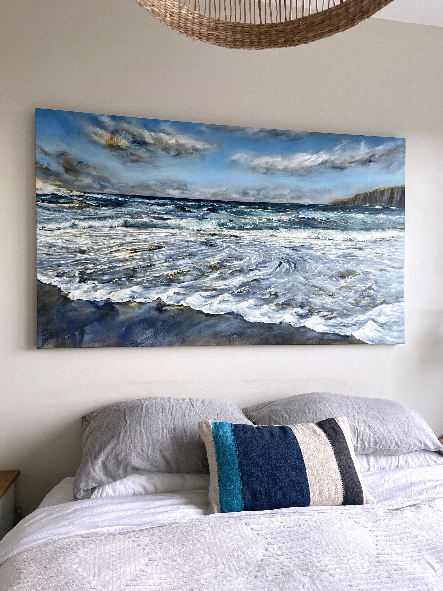 &quot;Emerald Sea&quot; shining brightly on a bedroom wall💙✨ I had several breakthroughs while painting this piece, one being learning how to capture the wild sea froth as it raced up the shore and curled back to return to the ocean. 

Observing the