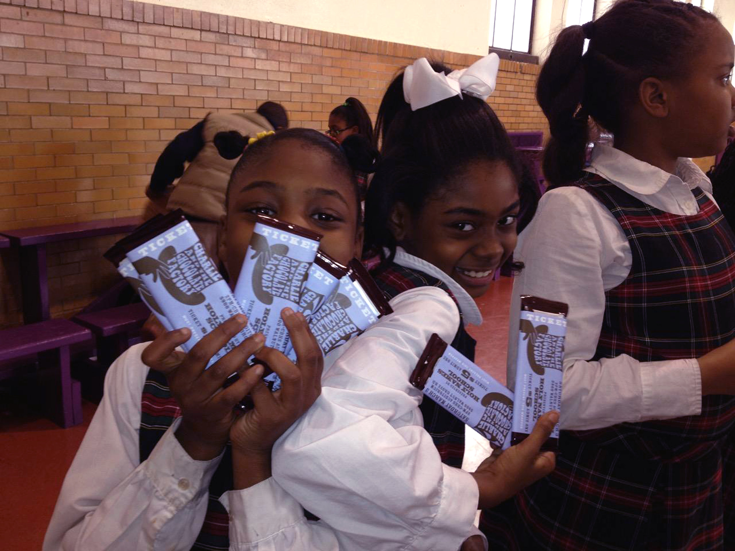  Students selling tickets that were wrapped around chocolate bars.  Photo courtesy Holy Names Jubilee School  Branding creative, copywriting and design by Chuck Mitchell  Pro bono work developed for Holy Names Jubilee School’s production of Charlie a