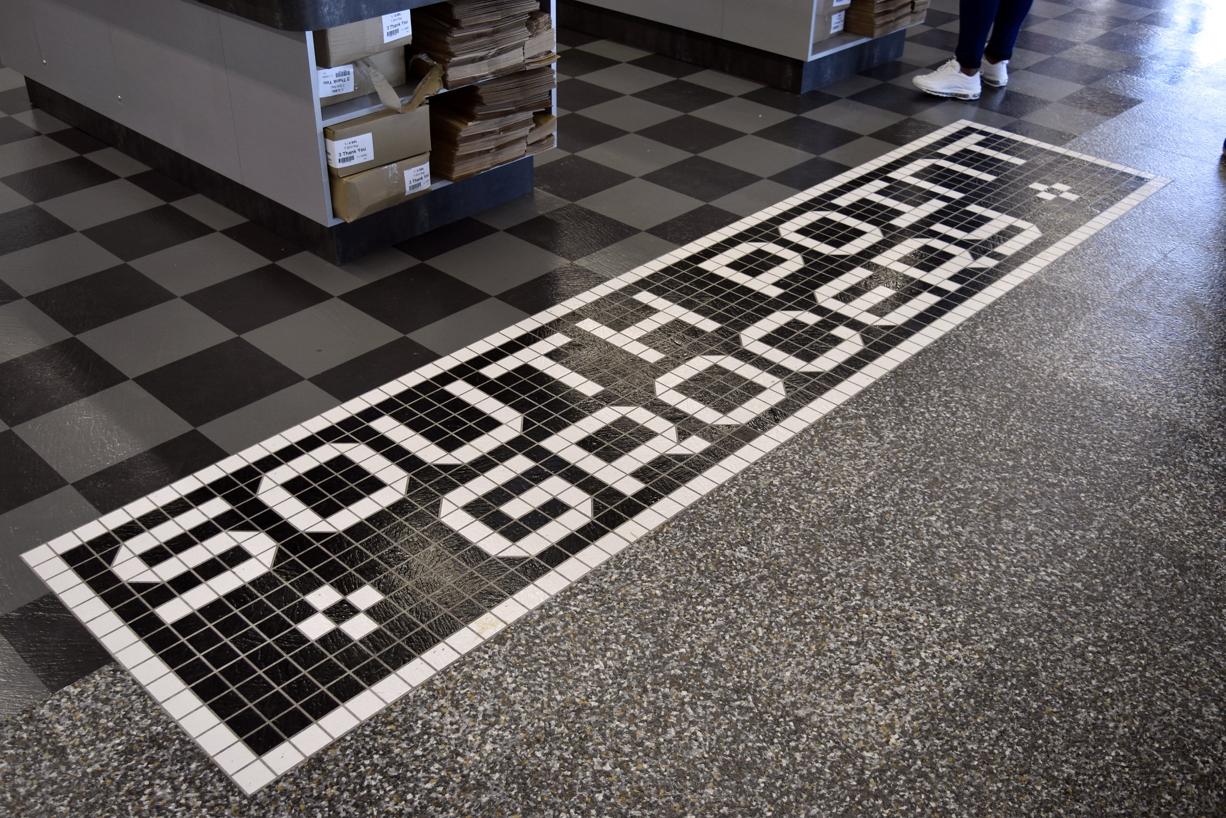  South Point Grocery  Downtown Memphis  South Point Grocery floor logo graphic  Branding creative and floor design by Chuck Mitchell  Logo font design by Chuck Mitchell and Whitt Mitchell  Floor fabrication by Tarkett  Floor installation by Joy Floor