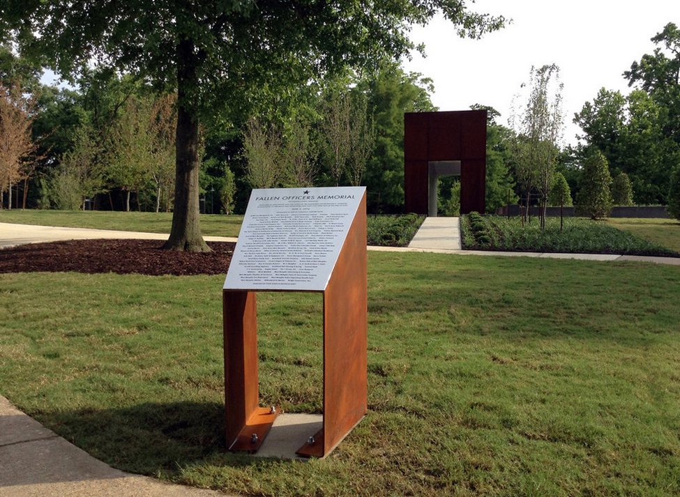  Fallen Officers Memorial Plaque &amp; Base  West Memphis, Arkansas  Designed by Chuck Mitchell  Fallen Officers Memorial (shown in background) designed by former University of Arkansas architecture students Tyler Jones and Brandon Bibby 