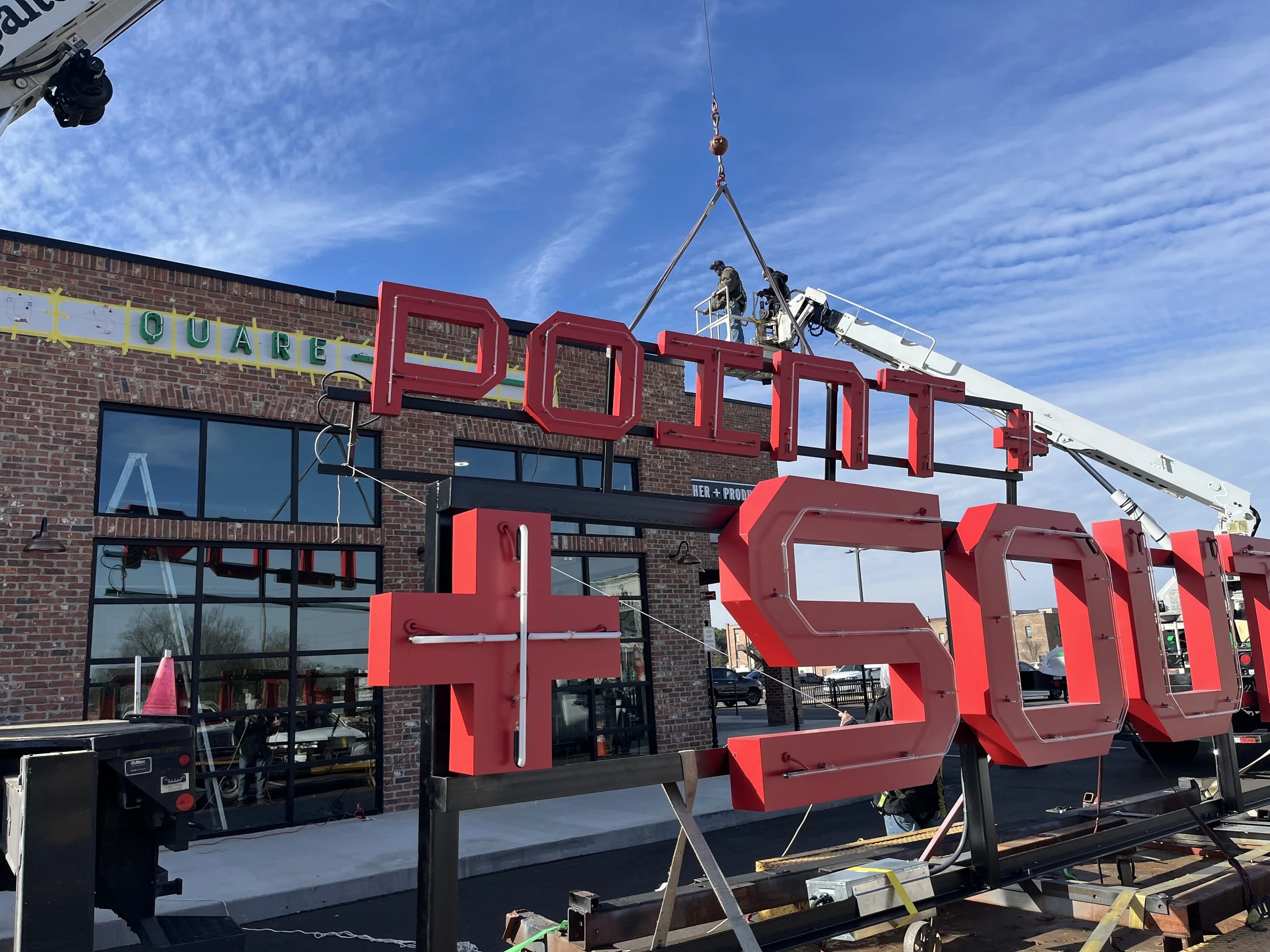  South Point Grocery Silo Square  Southaven, Mississippi  "SOUTH POINT" exterior neon sign installation  Branding creative and signage design by Chuck Mitchell  Sign fabrication and installation by Frank Balton Sign Company 