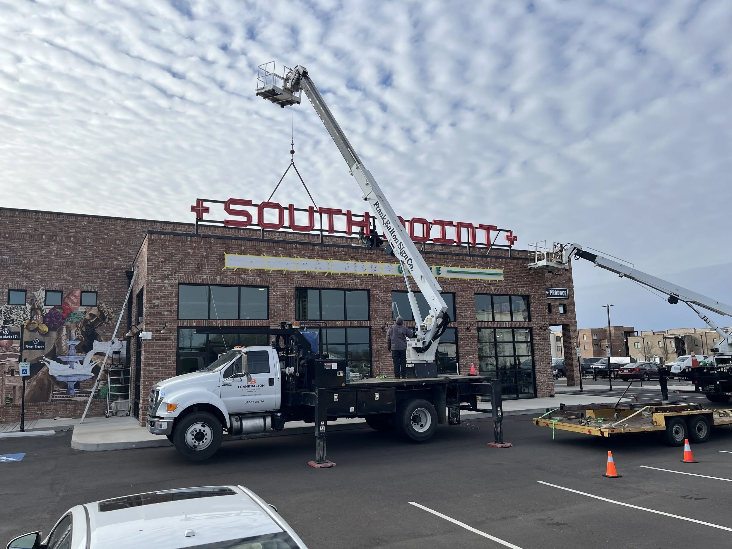  South Point Grocery Silo Square  Southaven, Mississippi  "SOUTH POINT" exterior neon sign installation  Branding creative and signage design by Chuck Mitchell  Sign fabrication and installation by Frank Balton Sign Company 