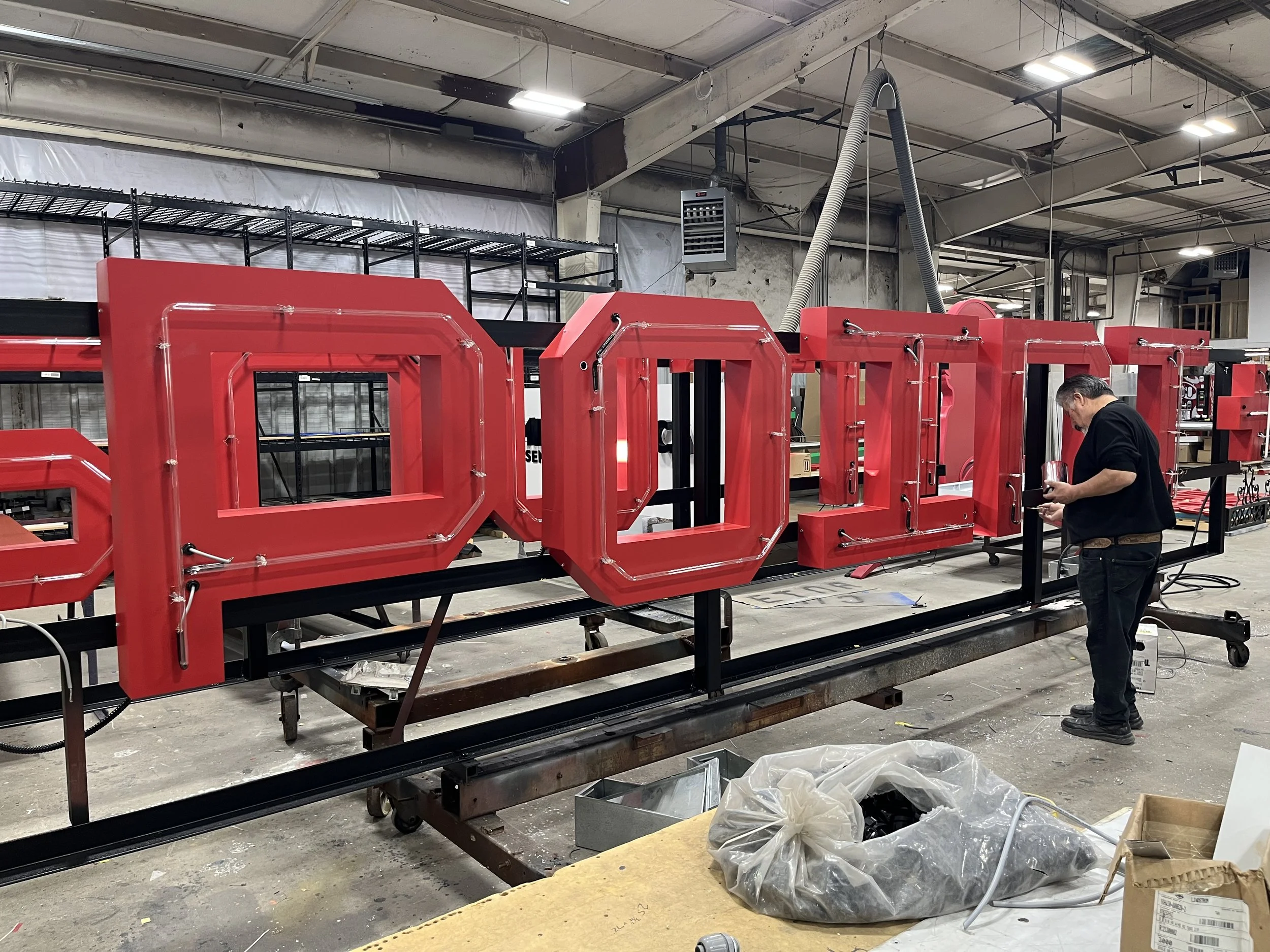  South Point Grocery Silo Square  Southaven, Mississippi  "SOUTH POINT" exterior neon sign in production  Branding creative and signage design by Chuck Mitchell  Sign fabrication and installation by Frank Balton Sign Company 