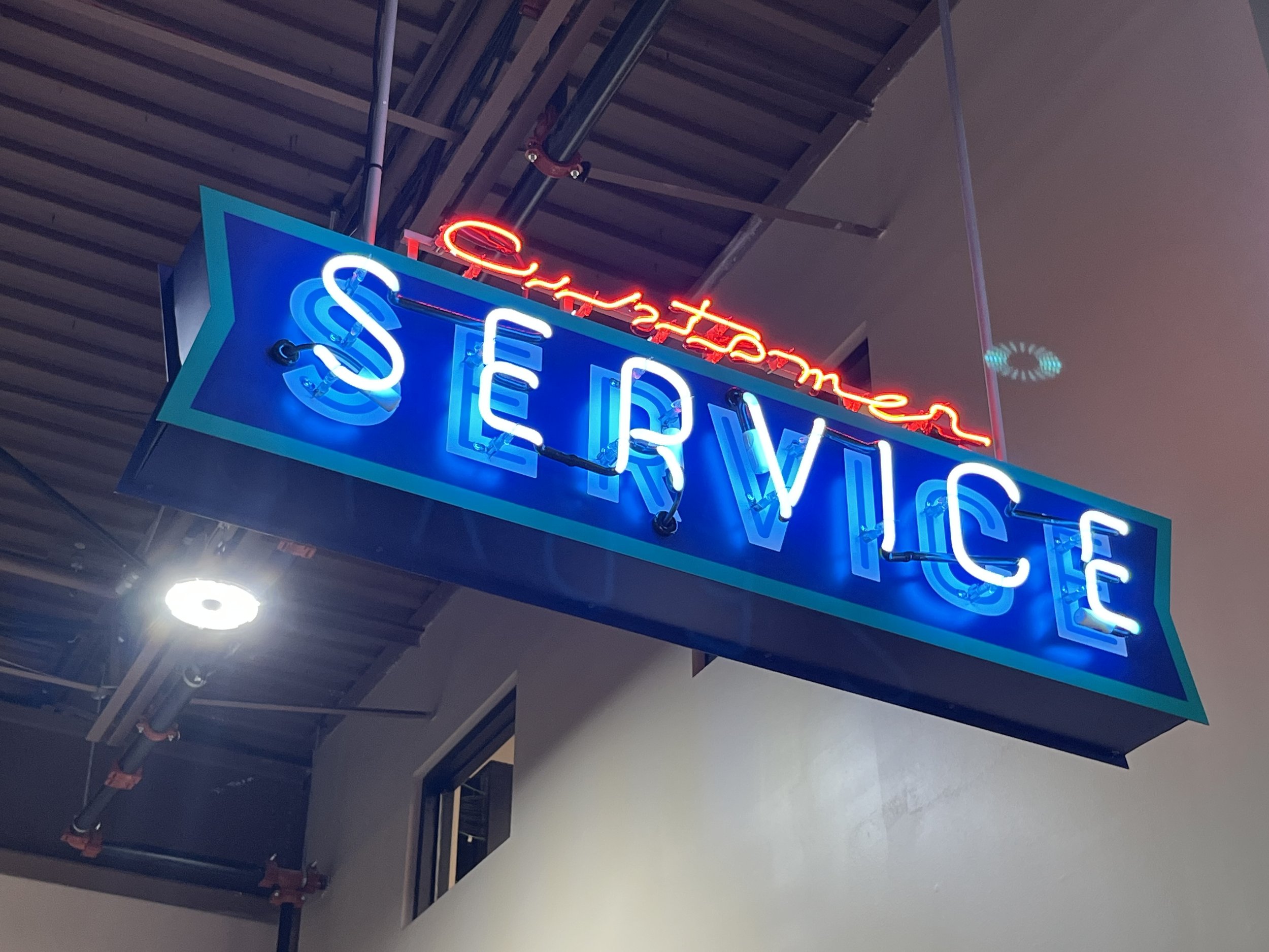  South Point Grocery Silo Square  Southaven, Mississippi  "CUSTOMER SERVICE" interior double-face neon sign  Branding creative and signage design by Chuck Mitchell  Sign fabrication and installation by Frank Balton Sign Company 