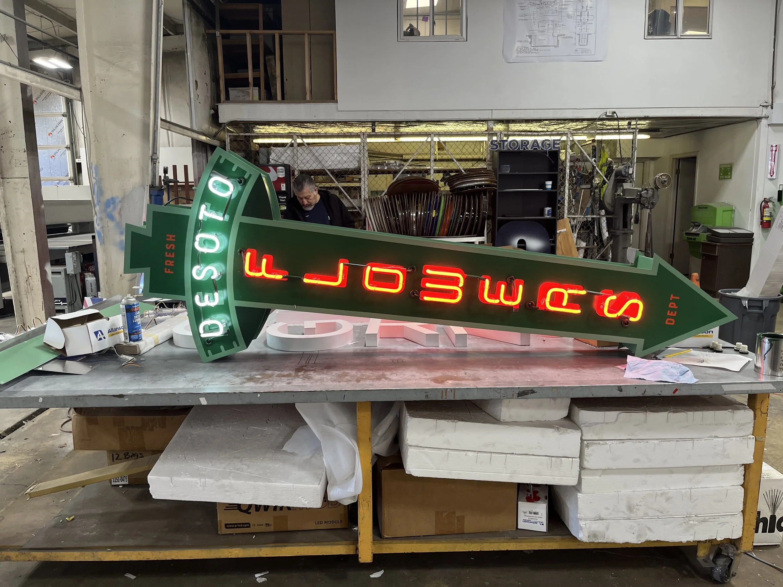  South Point Grocery Silo Square  Southaven, Mississippi  "DESOTO FLOWERS" interior double-face neon sign in production  Branding creative and signage design by Chuck Mitchell  Sign fabrication and installation by Frank Balton Sign Company 