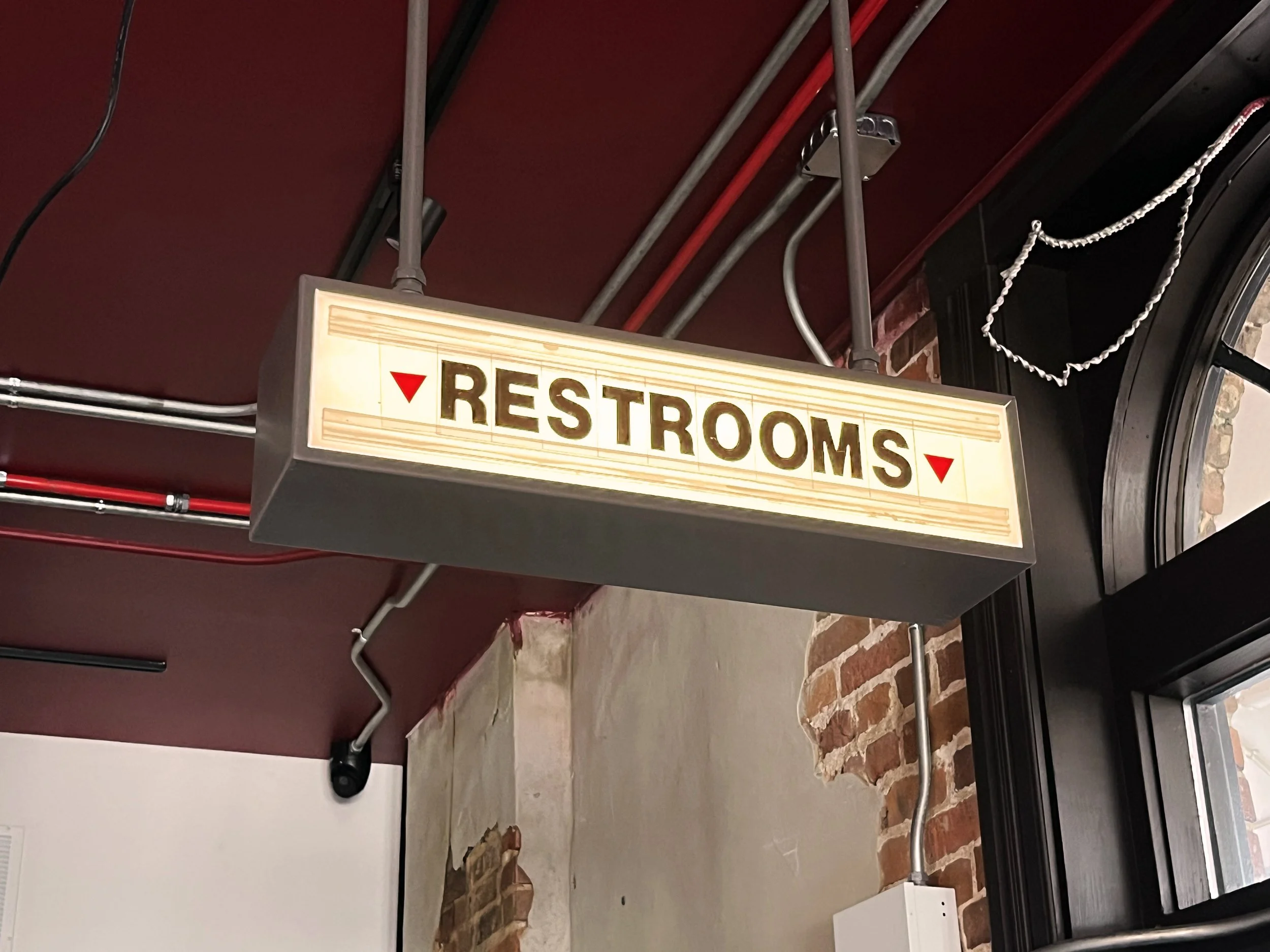  Back Home Barbecue  Little Rock, Arkansas  “RESTROOMS” &amp; “GET MORE TO GO” hanging interior sign with back-lighted changeable lettering  Sign development and unit design © Chuck Mitchell  Branding and signage package design creative developed by 