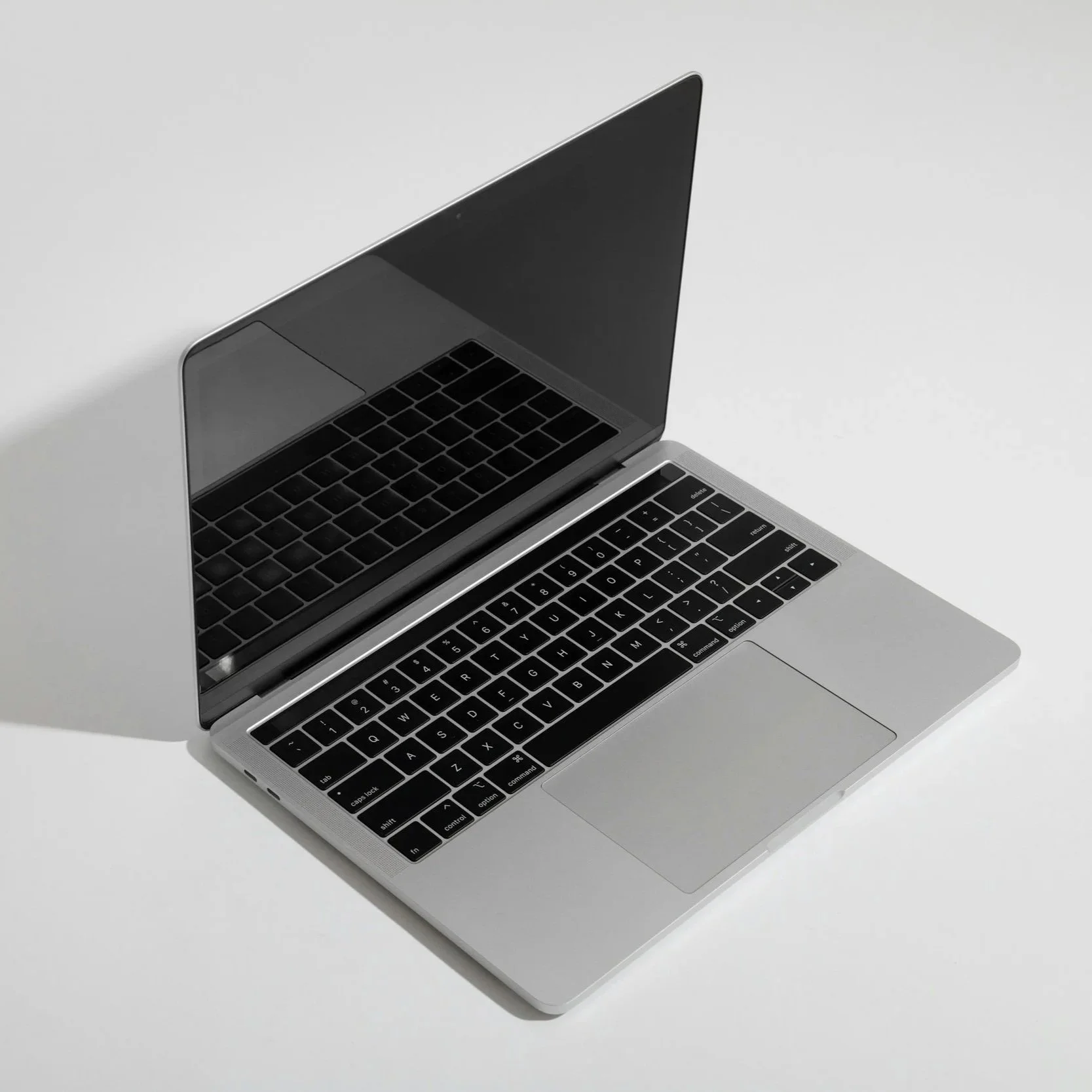 a laptop computer sits open on a white background