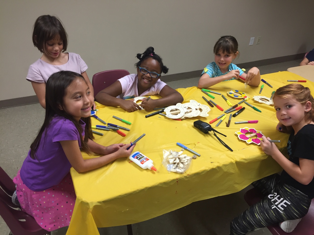 Decorating pinwheels with permanent markers. 