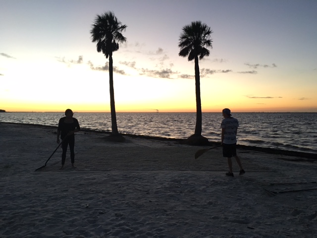 Elizabeth Baker and Jordan Peel smooth out the sand to create the set. 