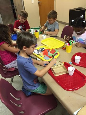 Campers used feathers, tissue paper, sequins and other materials to decoupage their storybook boxes.