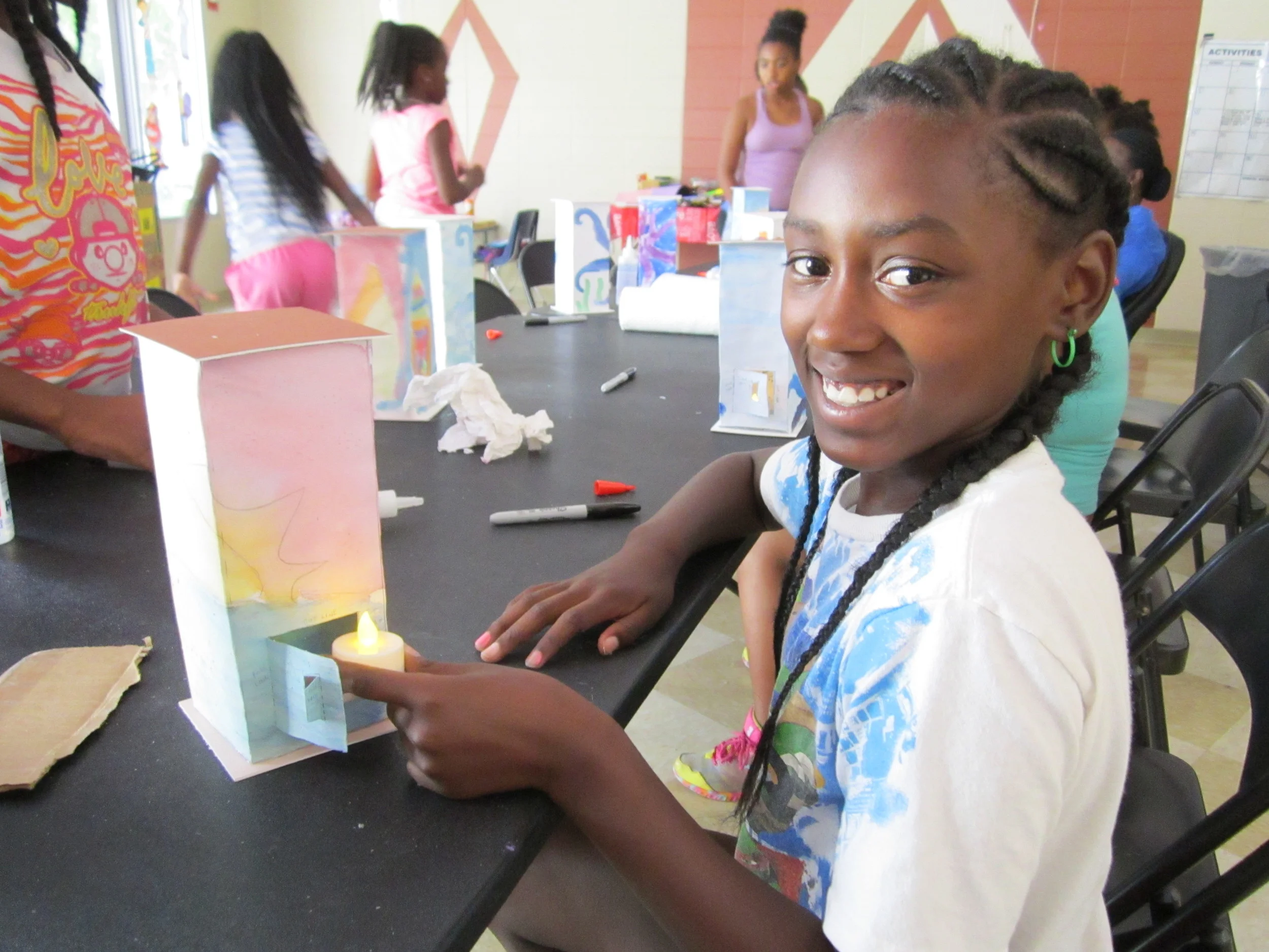 Thomas Jet Jackson girl proudly lights her beach lantern.