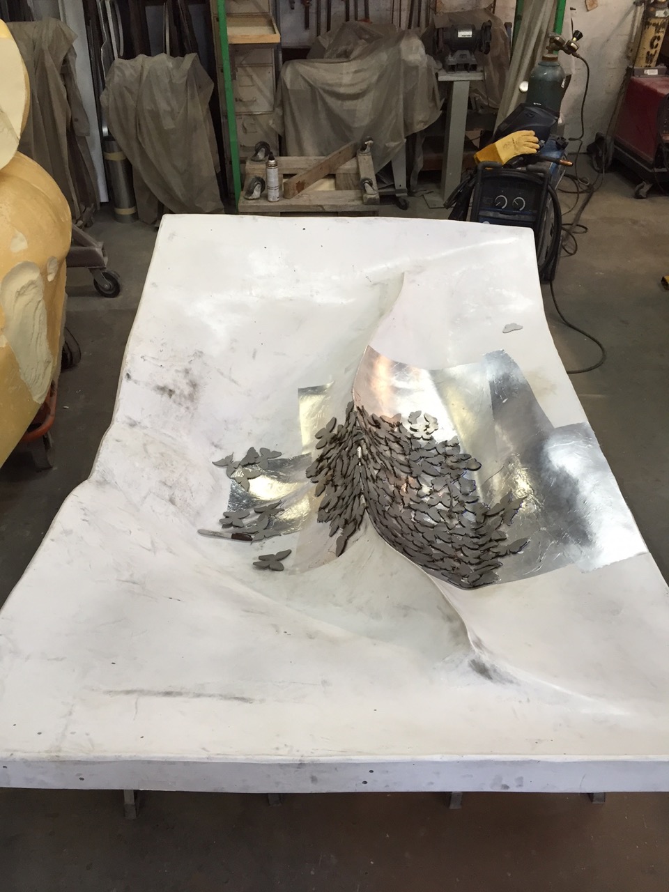 Here you can see the surface of the mold. It is a negative version of the lips. We have put a layer of foil on the surface to protect from the welding process.
