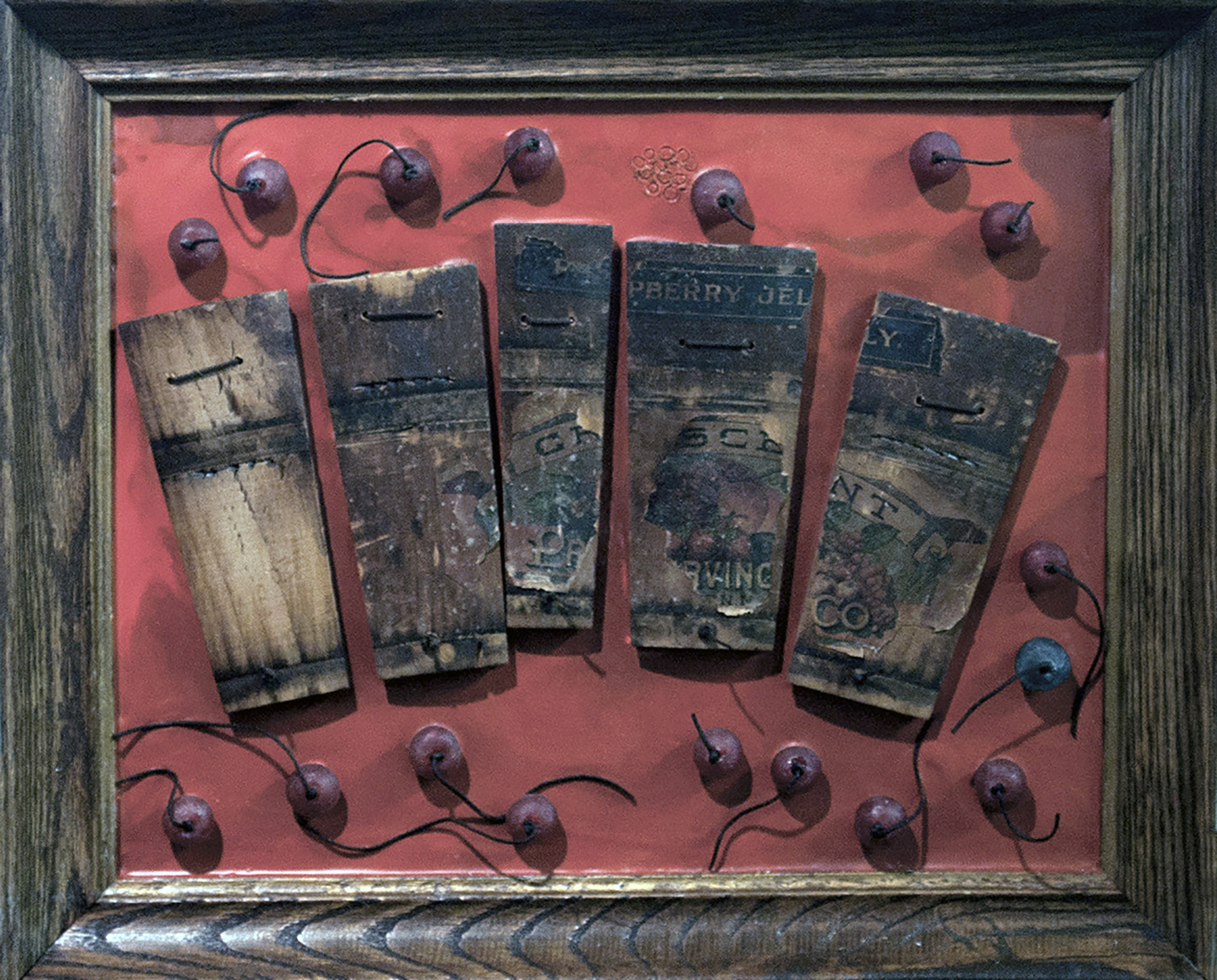 Raspberry Jelly. From a raspberry jelly wooden bucket, rearranged on an encaustic surface with cord and beads added and mounted in an old oak frame. 2014. 16"W X13"H x 2"D.