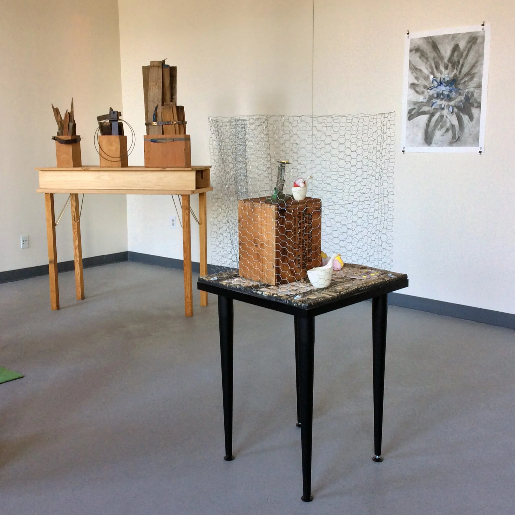 Gallery Installation 2015. Front: Fenced Eggs , 2014-2016 Bricolage. 33" x 55"H x 26". Rear: Three Parts , 2004. Constructed wood containers with arranged barrel staves and metal rings. 48"W x 38"H x 17"D.