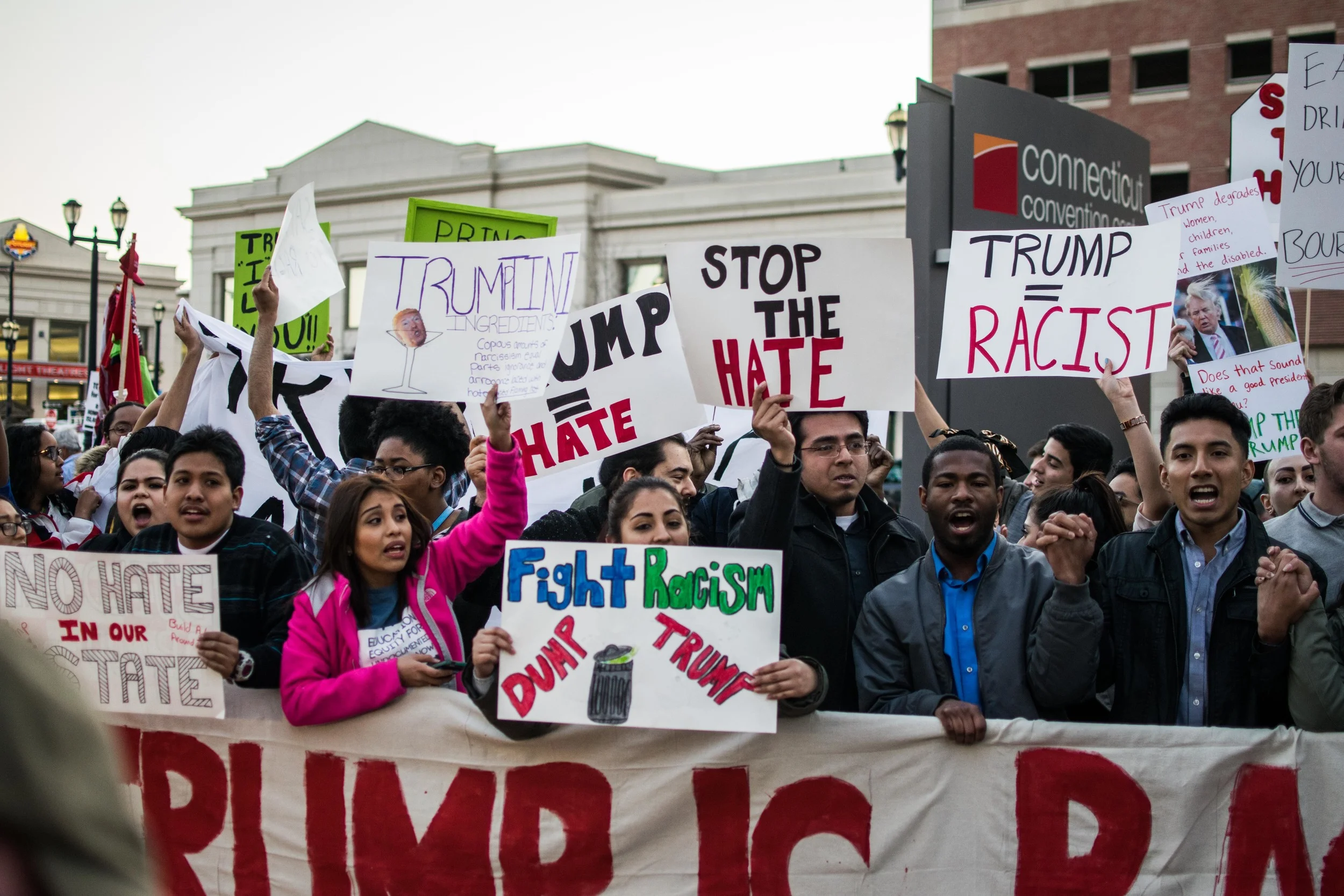 Protesters stand together in unity protesting Trump's proposed immigration reforms and the racism he represents to them.
