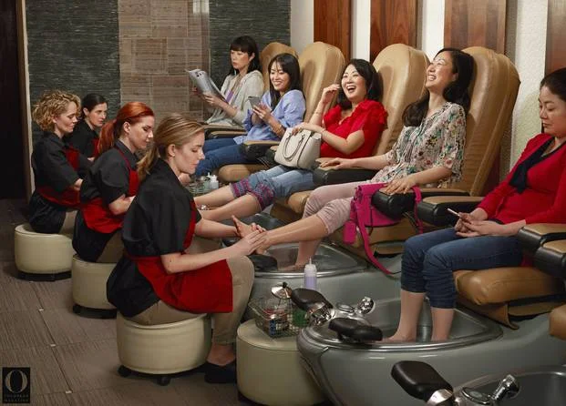 A nail salon where Asian women are having their pedicures done by white women. Source: Chris Buck/O, the Oprah Magazine