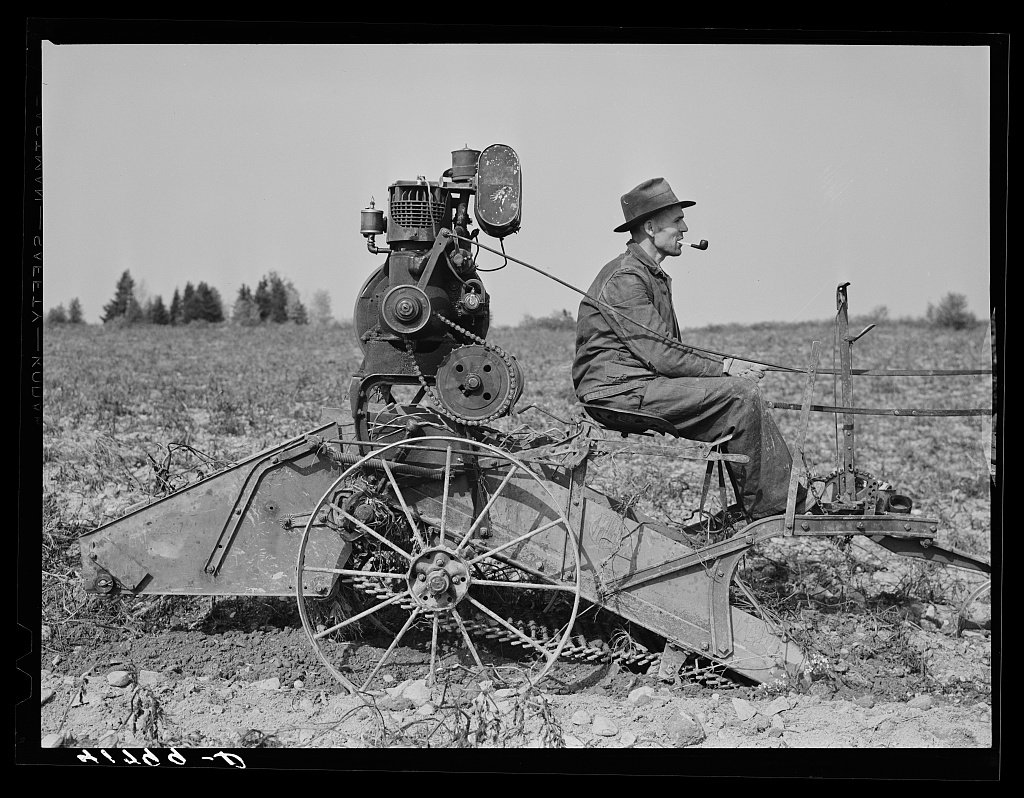 French-Canadian potato farmer on his horse-drawn digger on a small farm near Caribou, Maine. Jack Delano, 1940 Oct.