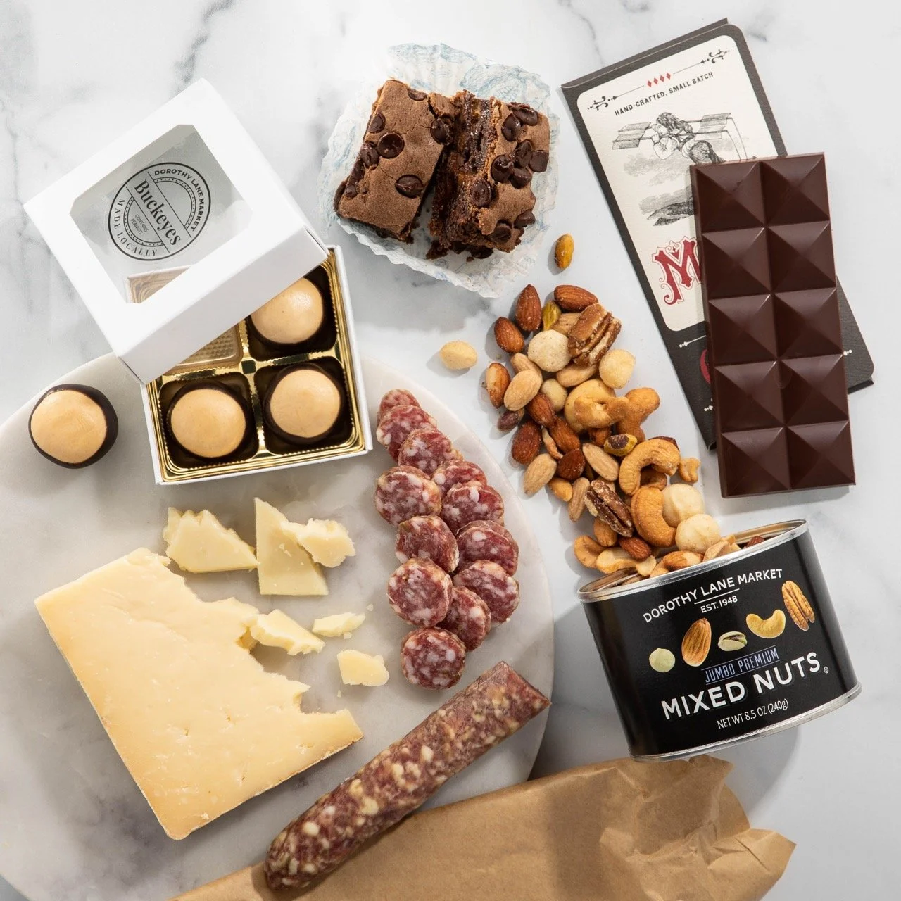 Ohio Artisan Gift Box featuring Urban Stead Cheese, Maverick Chocolate, Foris Salami, DLM Buckeyes, DLM Jumbo Premium Mixed Nuts, Prospect Jam Co. Strawberry Pink Peppercorn Jam, and our very own Killer Brownie