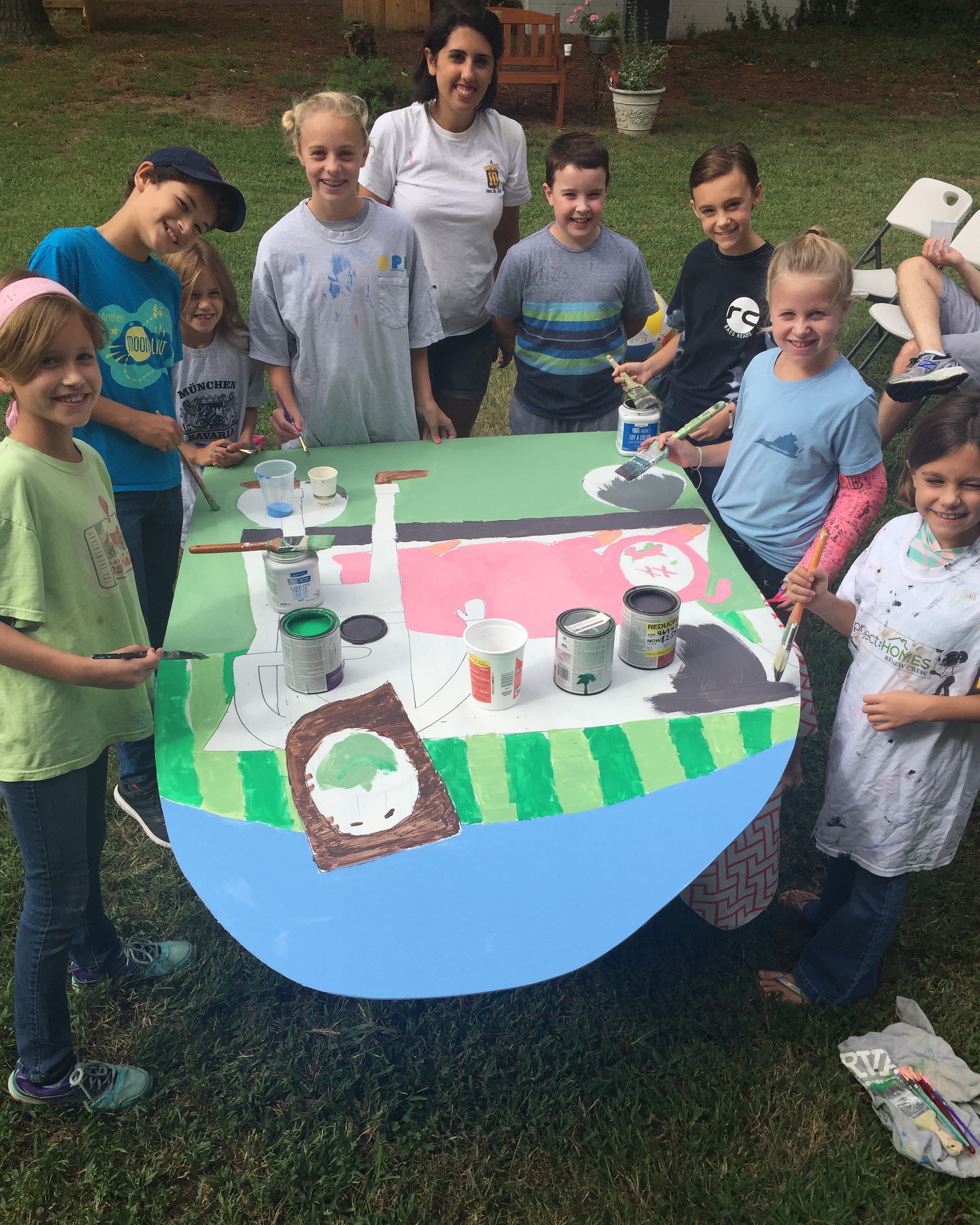 Pictured: Emily helping our City Kids tap into their creativity as they help prep for this year's Harvest Party .