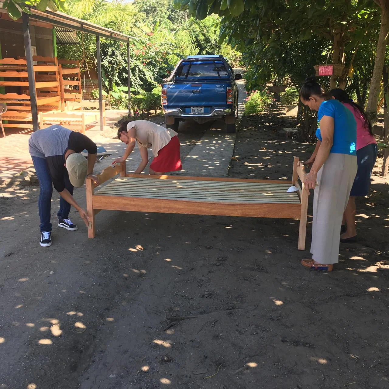 Pictured here are parents in the program sanding a bed. This helped reduce the cost of the bed. Each parent that has a child attending the center is required to give back. #teameffort