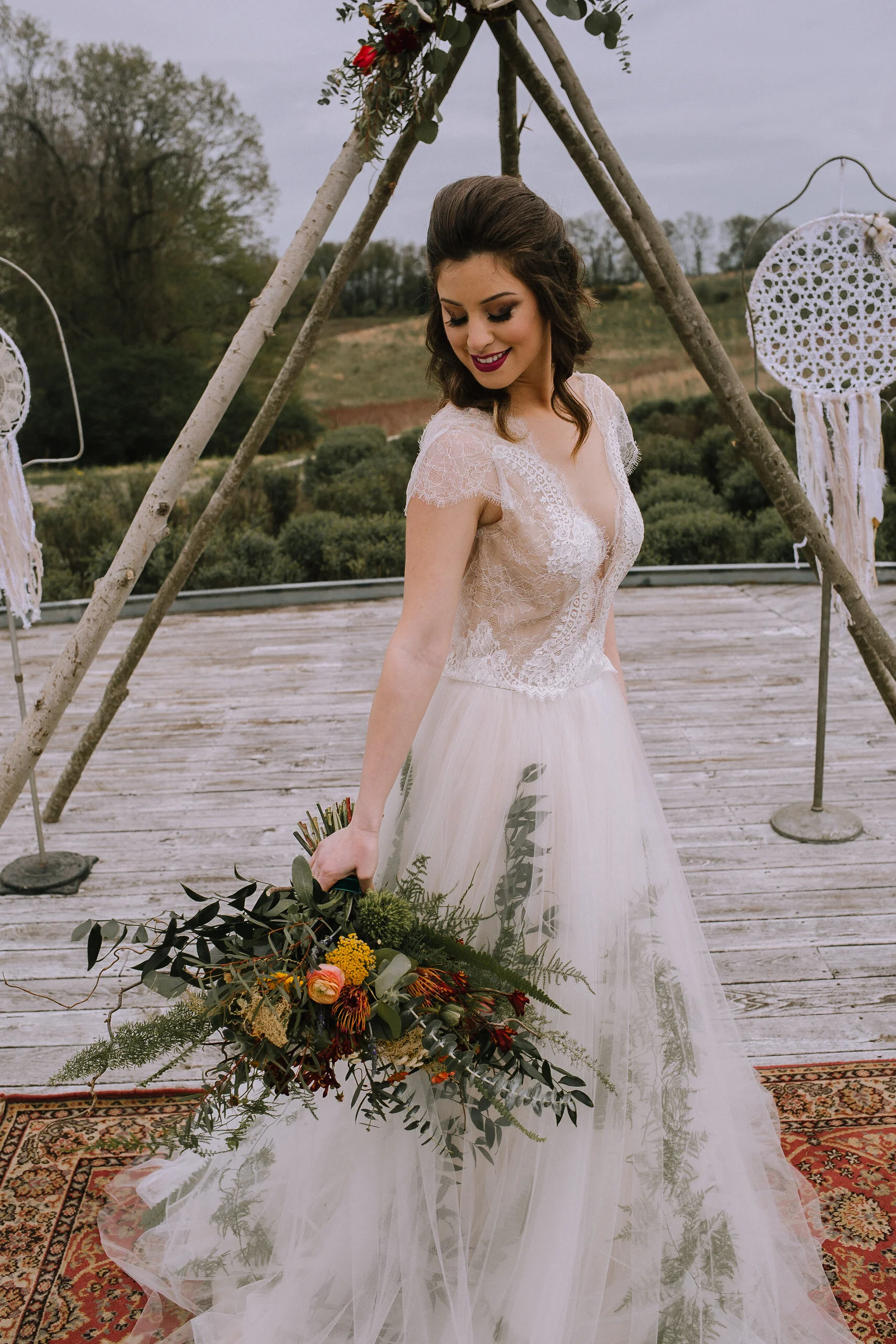 Melissa gown by Divine Atlier from Blanc de Blanc Bridal. Bohemian flower bouquet from Community Flower Shop at Chatham University Eden Hall campus wedding. Teepee and dreamcatchers from Vintage Alley Rentals.