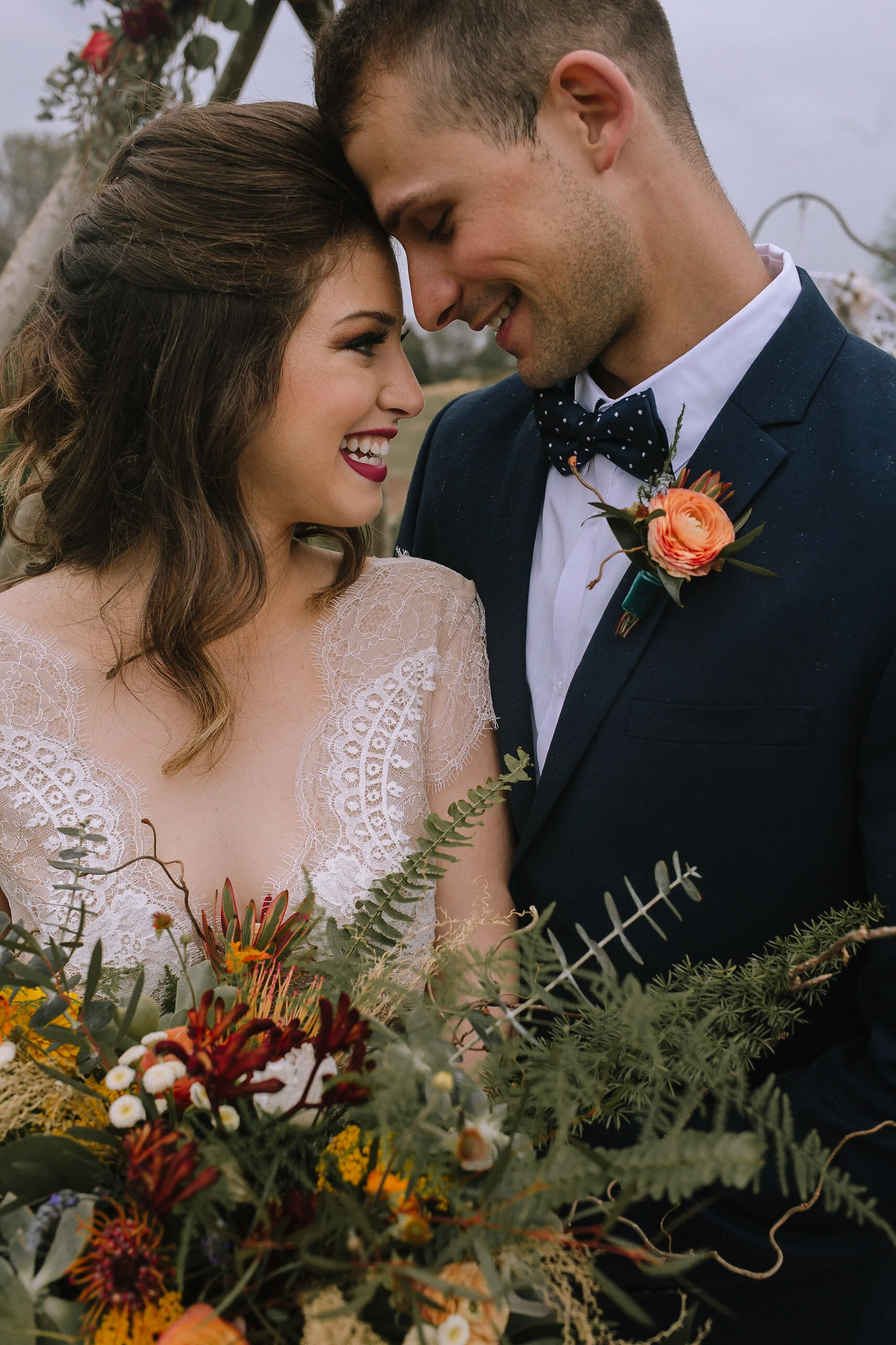 Bride and groom wearing Blanc de Blanc Bridal and H&M. Flowers from Community Flower Shop.