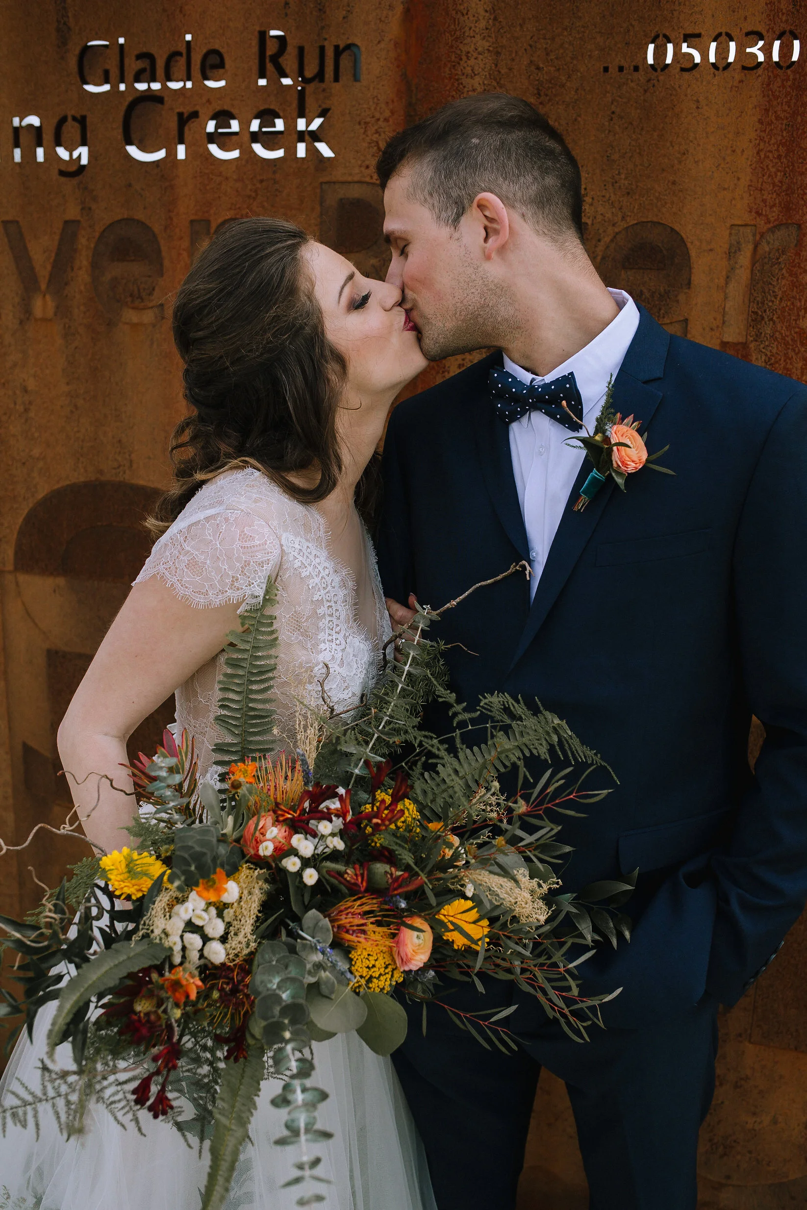 Bohemian wedding at Chatham University, Eden Hall Farm designed by Exhale Events. Bride's look from Blanc de Blanc Bridal, Melissa Gown by Divine Atelier. Groom's suit from H&M. Bridal bouquet and boutineer from Community Flower Shop. Hair & makeup by JL Makeup Studio.