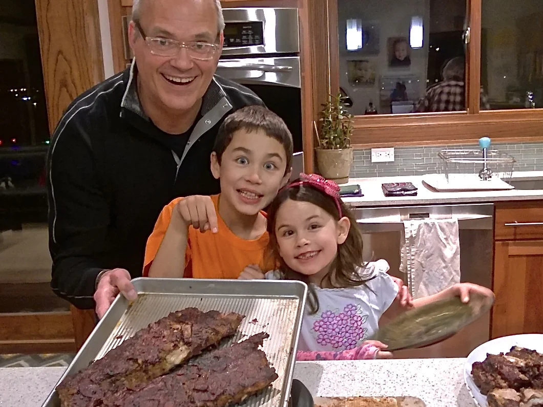 Two happy cooking (and eating) assistants in Wayne, NE — by the way, these ribs in a homemade plum sauce are THE BOMB!