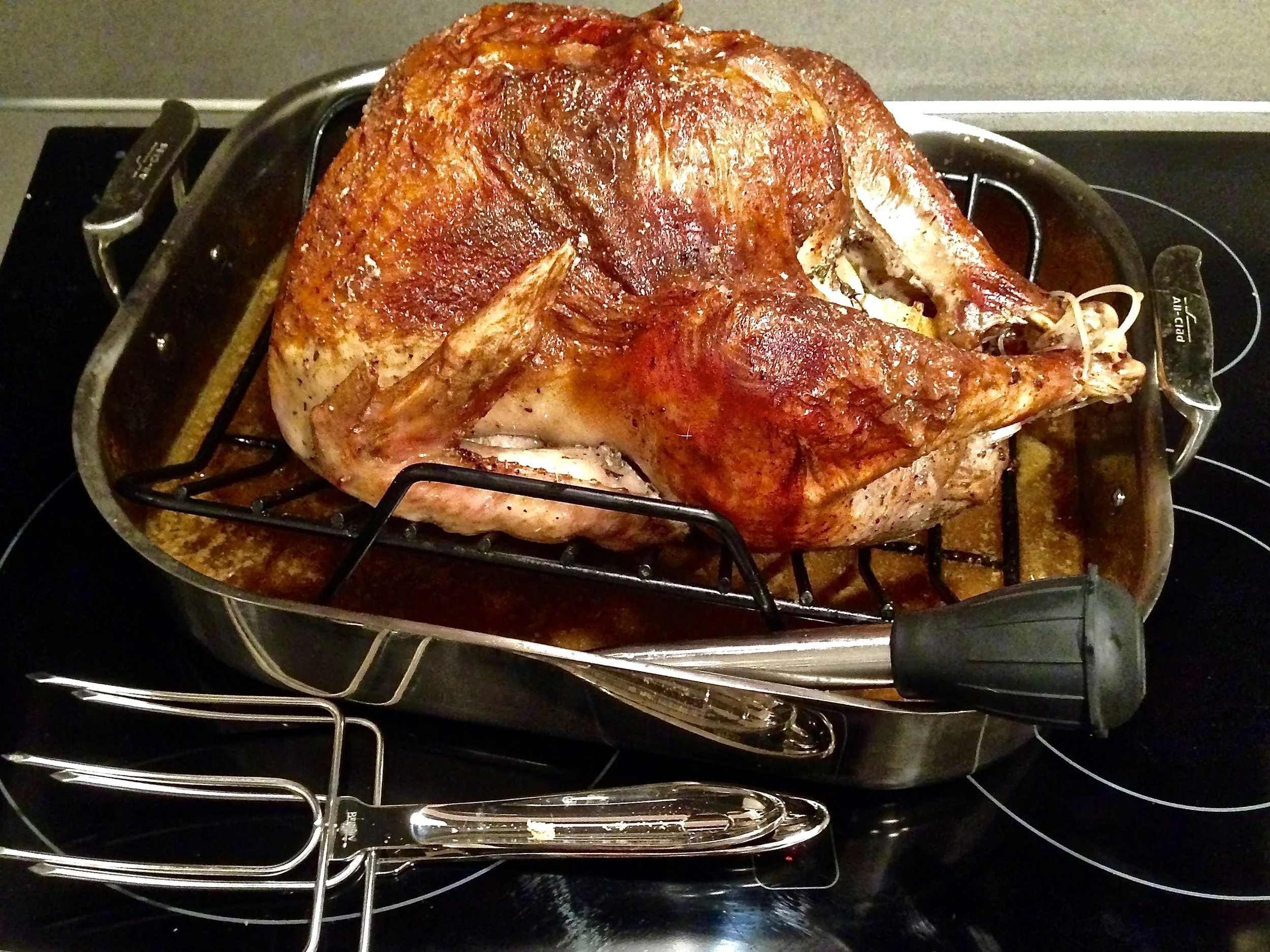 A beautifully brined, perfectly roasted turkey waiting to be carved as part of Thanksgiving dinner in Portland, OR