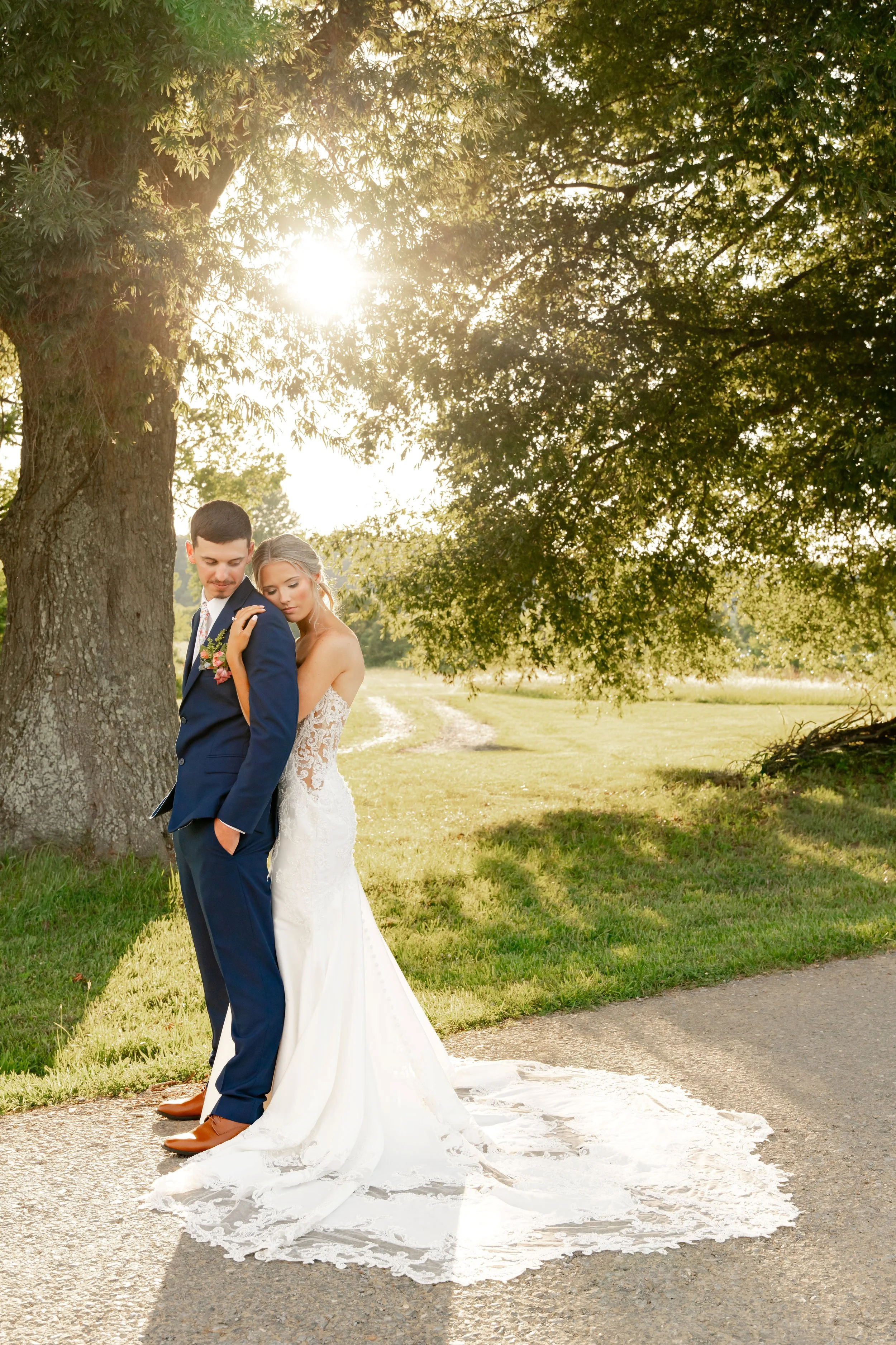 Bride and groom under a tree during their summer wedding at The Farm at Bentley Fields in East Tennessee